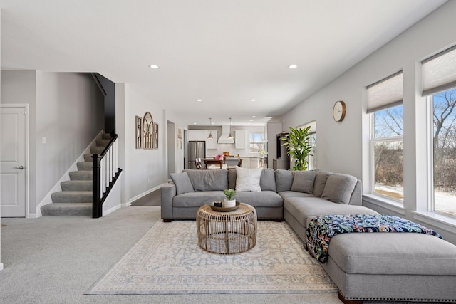 carpeted living room featuring stairway, recessed lighting, and baseboards