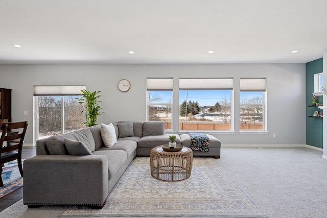 living room with recessed lighting, carpet, and baseboards