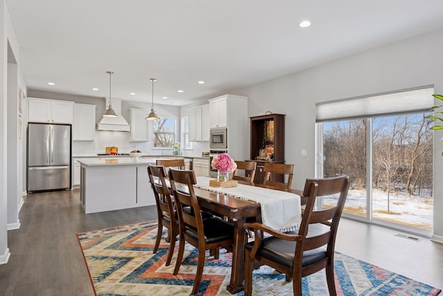 dining area with dark wood-style floors, recessed lighting, and visible vents