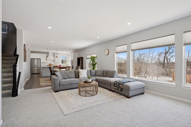 living room featuring recessed lighting, baseboards, carpet floors, and stairs