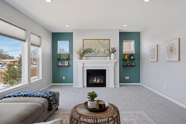 carpeted living area featuring a tiled fireplace, recessed lighting, and baseboards