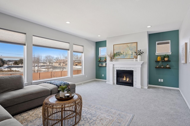 carpeted living room featuring a glass covered fireplace, recessed lighting, and baseboards