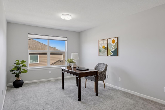 carpeted home office featuring baseboards