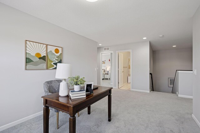 office space featuring visible vents, carpet floors, and baseboards