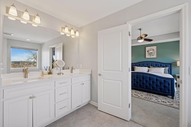 full bathroom with visible vents, a ceiling fan, a sink, ensuite bath, and double vanity