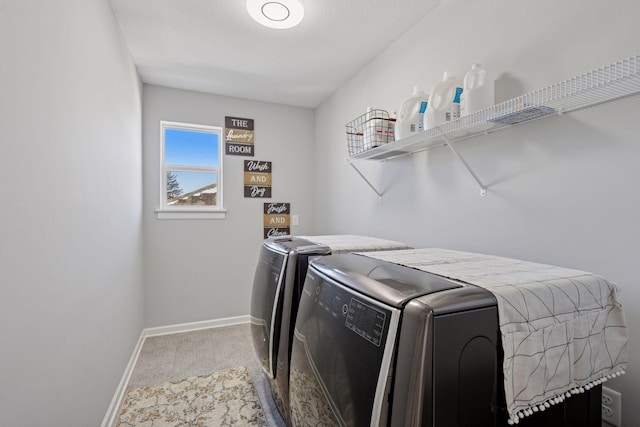 laundry area with baseboards, separate washer and dryer, laundry area, and carpet