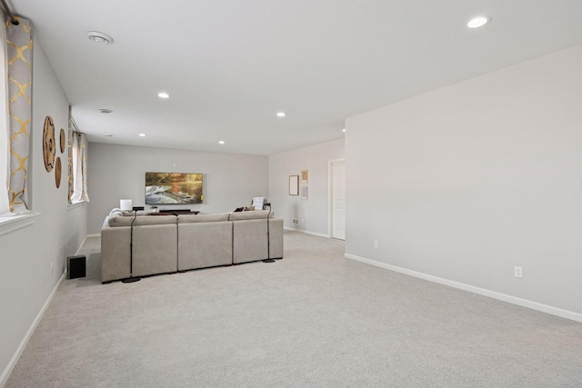 living area with recessed lighting, baseboards, and light colored carpet