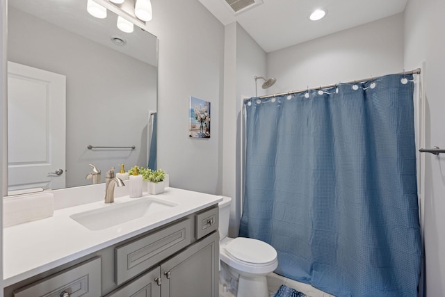 bathroom featuring visible vents, toilet, vanity, and a shower with curtain