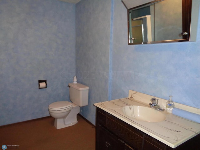 bathroom featuring vanity and toilet