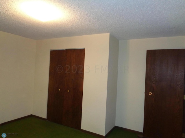 bedroom with a textured ceiling, a closet, and baseboards