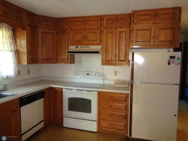 kitchen with brown cabinets, white appliances, light countertops, and under cabinet range hood