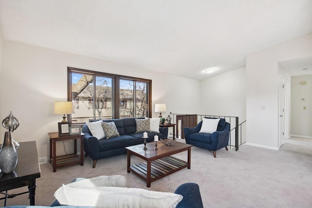 living area featuring baseboards and light colored carpet