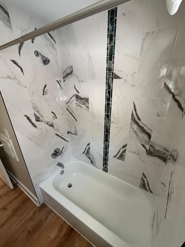 bathroom featuring shower / bathing tub combination and wood finished floors