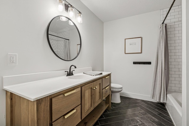 bathroom featuring shower / tub combo, baseboards, toilet, wood finished floors, and vanity