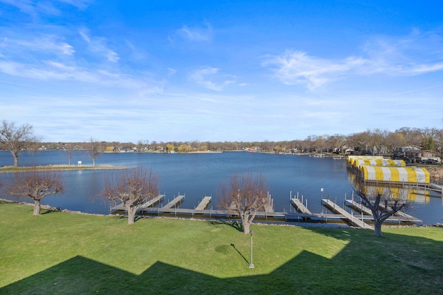 exterior space with a water view and a lawn