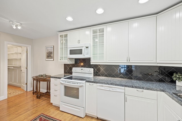 kitchen featuring white appliances, glass insert cabinets, light wood-style floors, white cabinetry, and backsplash