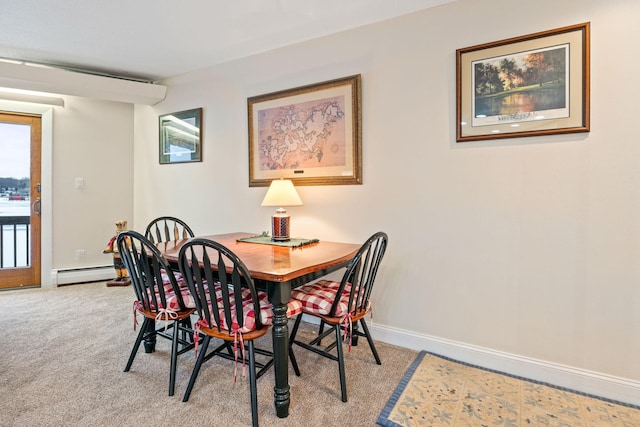 dining space featuring carpet floors, a baseboard radiator, and baseboards