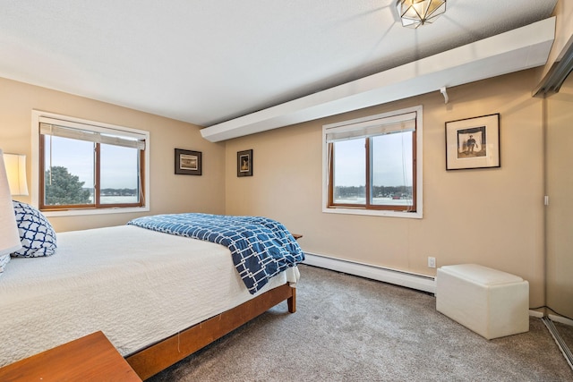 carpeted bedroom featuring a baseboard heating unit