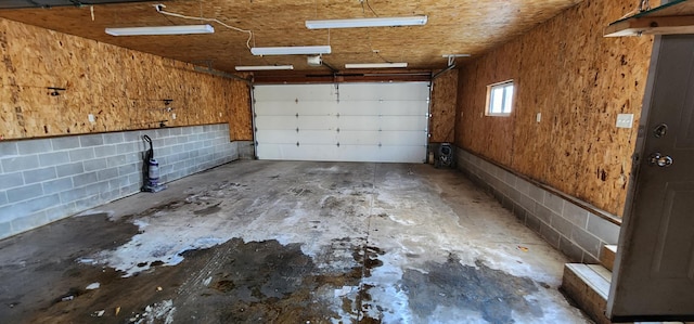 garage with concrete block wall