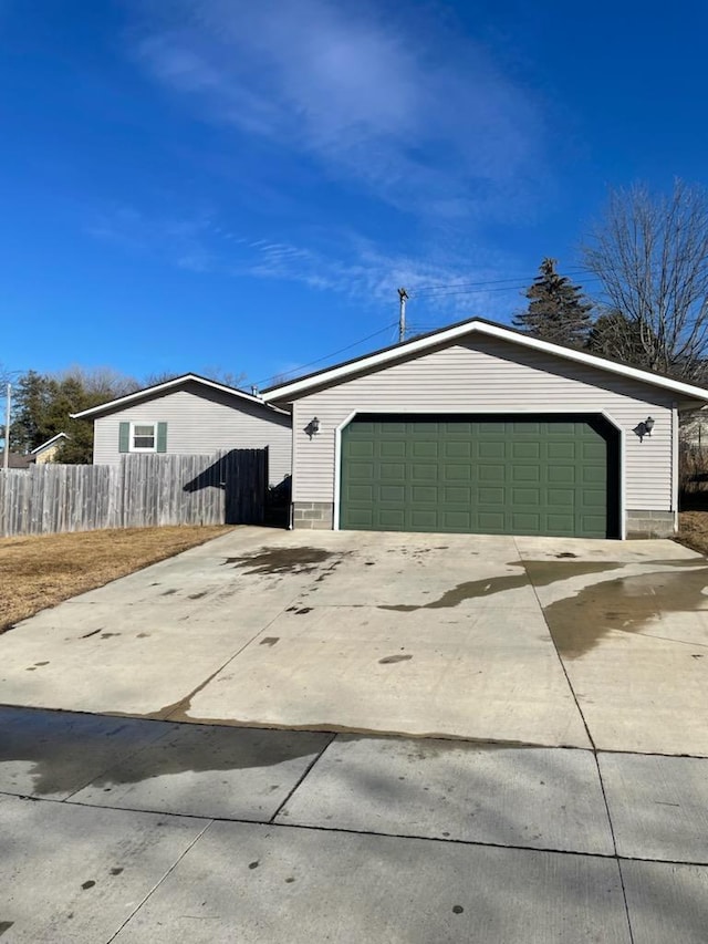 view of front of house featuring an outbuilding, fence, and a garage