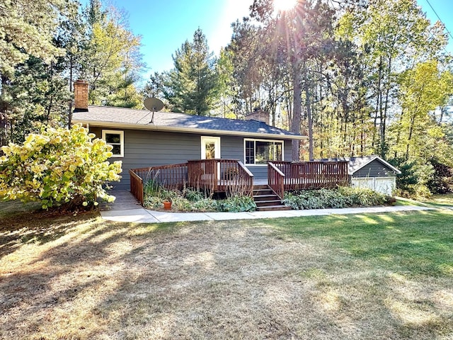 ranch-style house featuring a front lawn, a chimney, and a wooden deck