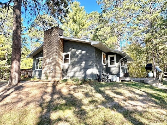 view of property exterior featuring a chimney