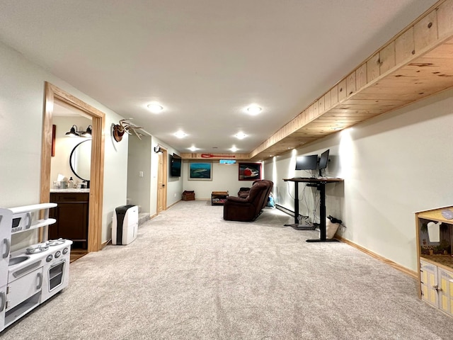 living area featuring light carpet and baseboards