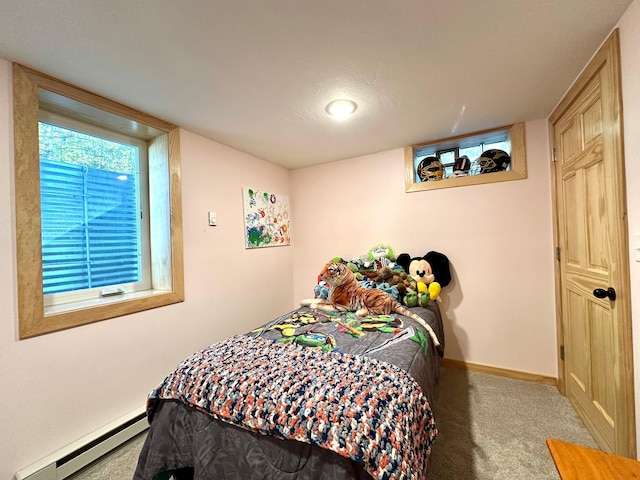 carpeted bedroom featuring a baseboard radiator and baseboards