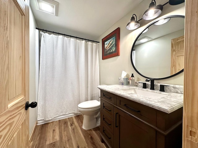 full bath with vanity, toilet, and wood finished floors