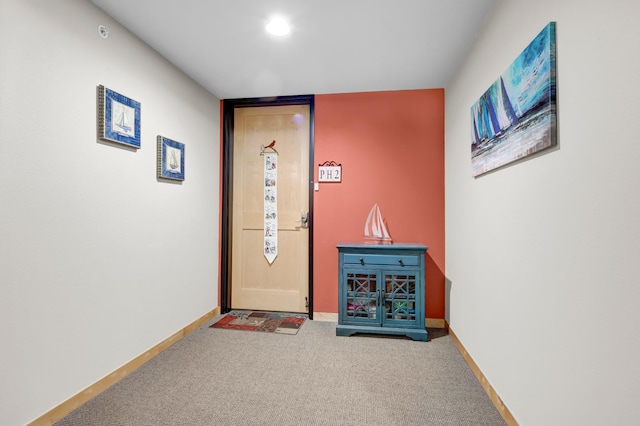 interior space featuring carpet and baseboards