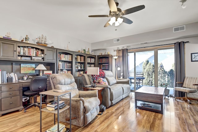 living area with visible vents, ceiling fan, and light wood-style flooring