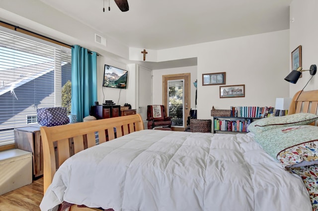 bedroom with light wood-type flooring, visible vents, and a ceiling fan