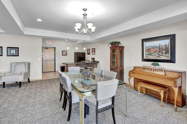 dining room with an inviting chandelier, baseboards, a tray ceiling, and recessed lighting