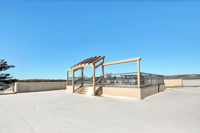 view of property's community with fence and a pergola