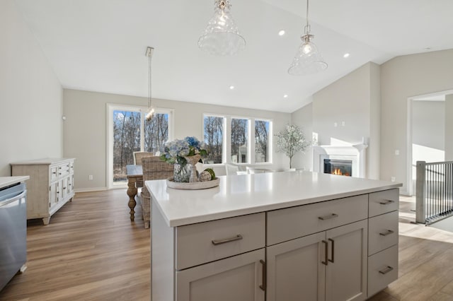 kitchen with open floor plan, light countertops, gray cabinets, and pendant lighting