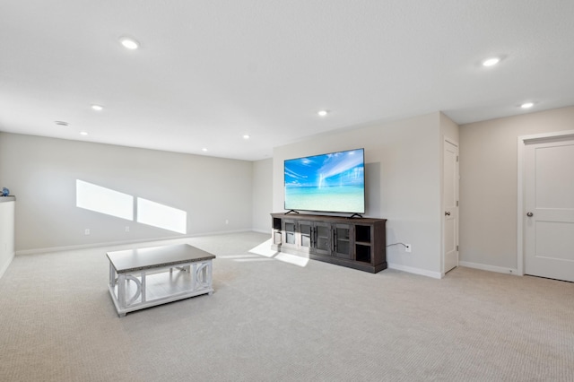 living area with light carpet, baseboards, and recessed lighting