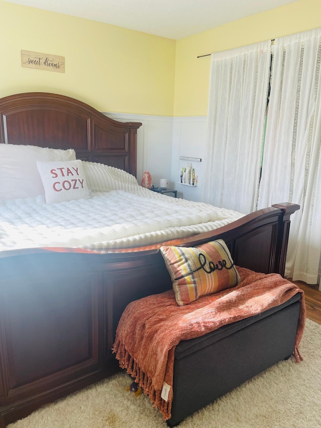 bedroom with a wainscoted wall