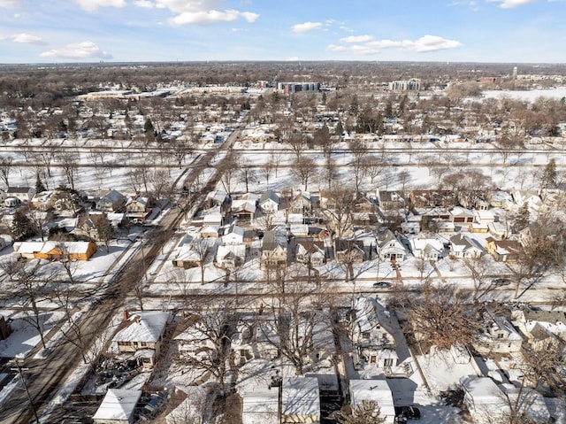 snowy aerial view with a residential view