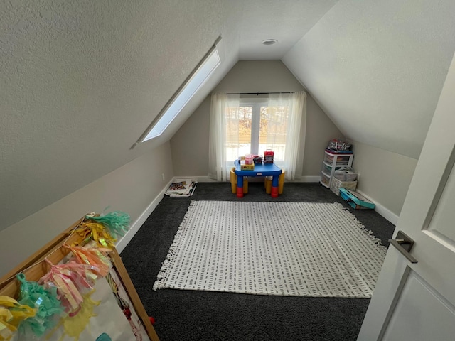 additional living space featuring vaulted ceiling, baseboards, dark colored carpet, and a textured ceiling