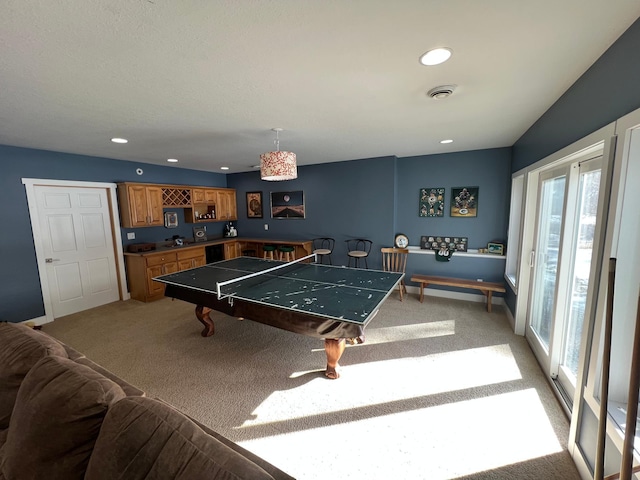 recreation room with indoor bar, recessed lighting, visible vents, light carpet, and baseboards