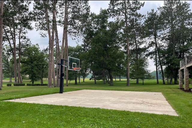 view of sport court with community basketball court and a lawn