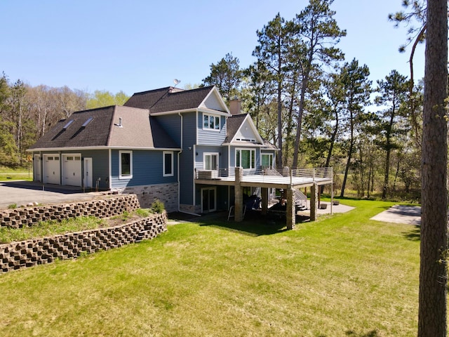 13849 Leaf River Rd, Wadena, MN 56482 - back of property featuring stairway, a wooden deck, asphalt driveway, a lawn, and a garage