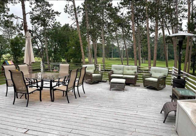 13849 Leaf River Rd, Wadena, MN 56482 - wooden deck featuring outdoor lounge area, view of scattered trees, and outdoor dining area