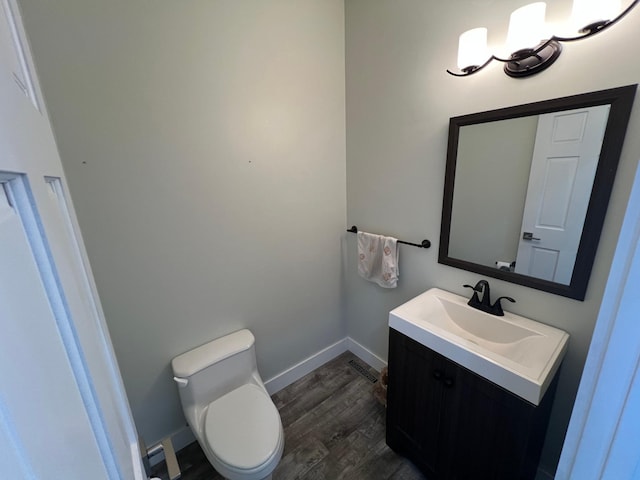 13849 Leaf River Rd, Wadena, MN 56482 - bathroom featuring wood finished floors, vanity, toilet, and baseboards