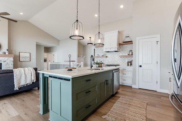 kitchen with stainless steel appliances, light wood finished floors, light countertops, and white cabinets