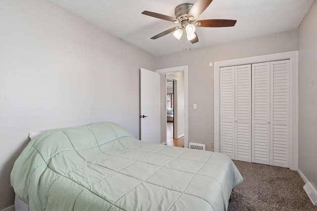 carpeted bedroom with ceiling fan, visible vents, baseboards, and a closet