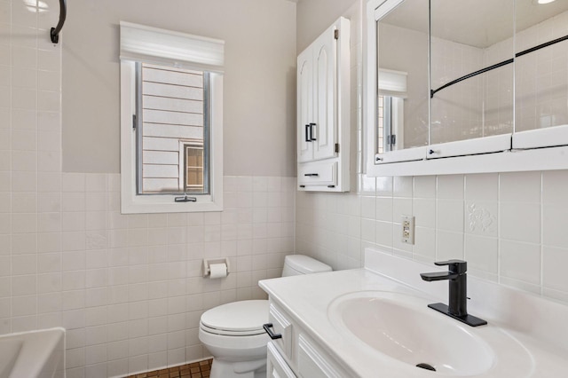 full bath with a tub to relax in, toilet, vanity, tile walls, and walk in shower