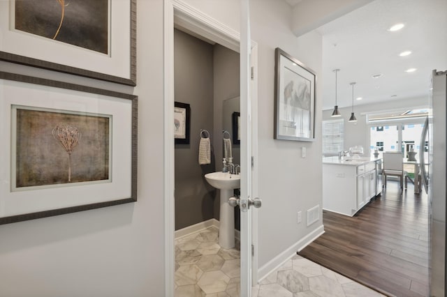 bathroom featuring baseboards, visible vents, and recessed lighting