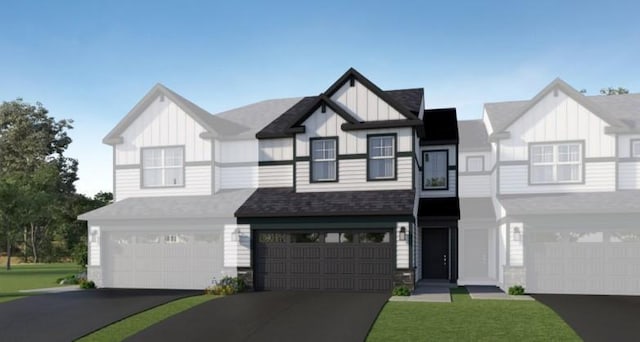 view of front of home featuring board and batten siding, a garage, and aphalt driveway