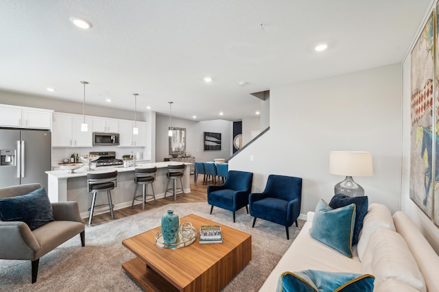 living area featuring recessed lighting and light wood-style flooring